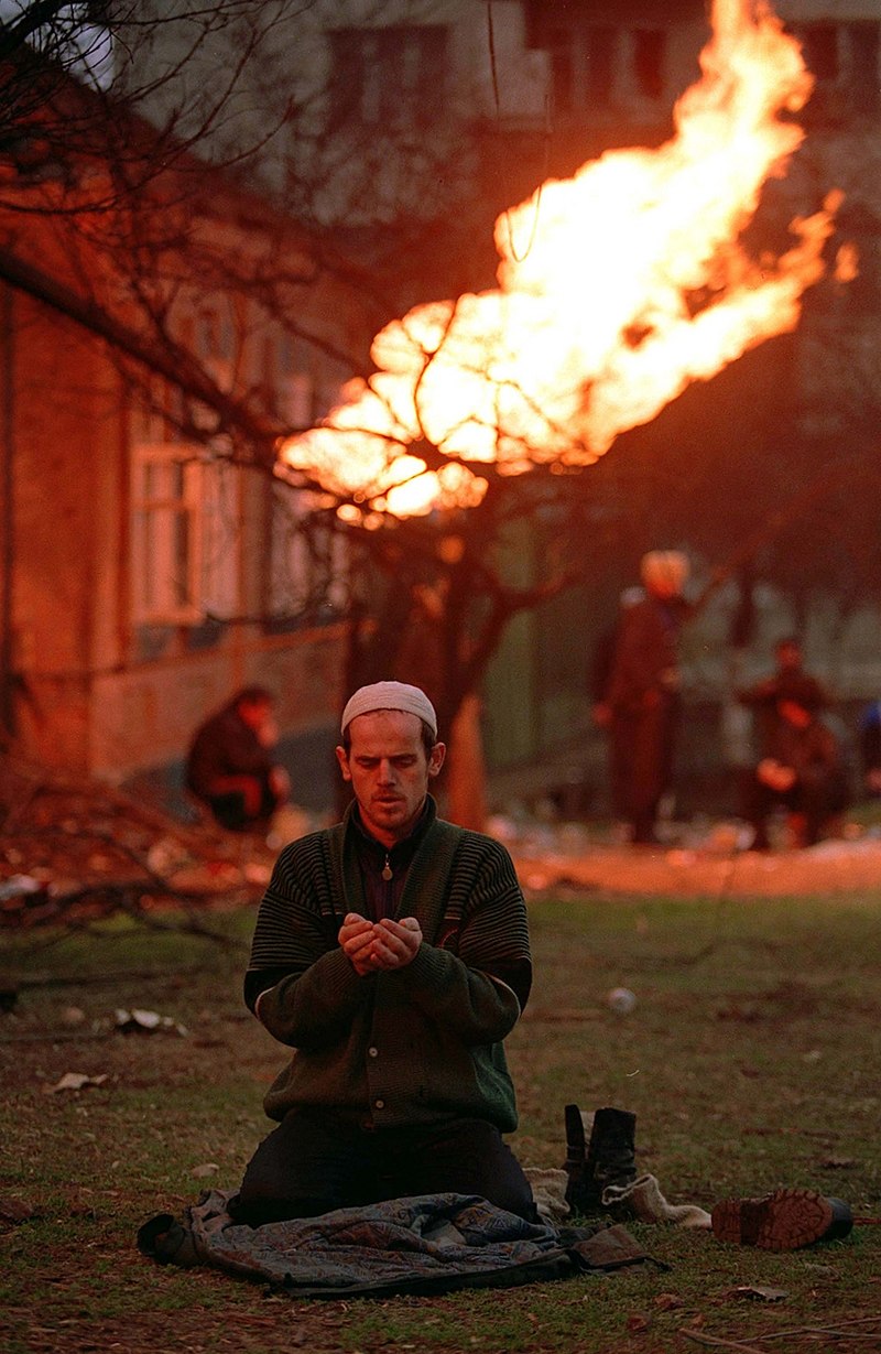 A Chechen civilian prays in Grozny January 1995 Mikhail Evstafiev