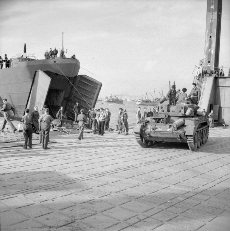 A Crusader AA tank comes ashore from an LST onto the pierhead at the Mulberry artificial harbour at Arromanches Harrison