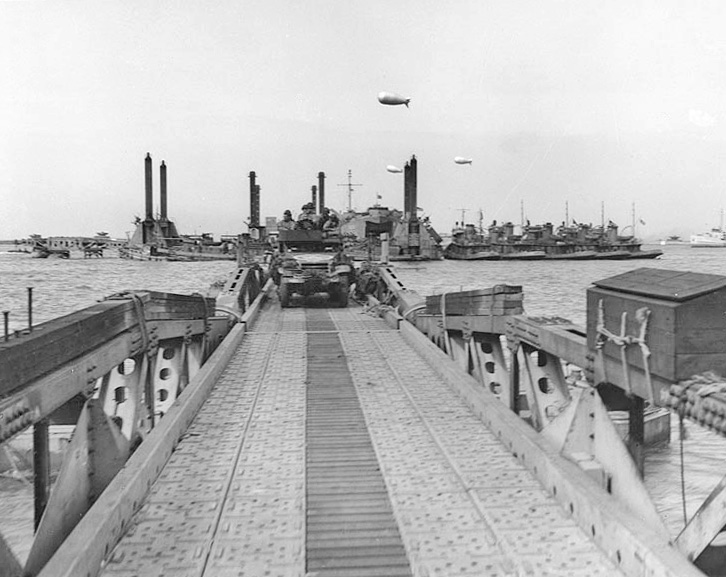 A Whale floating roadway leading to a Spud pier at Mulberry A off Omaha Beach