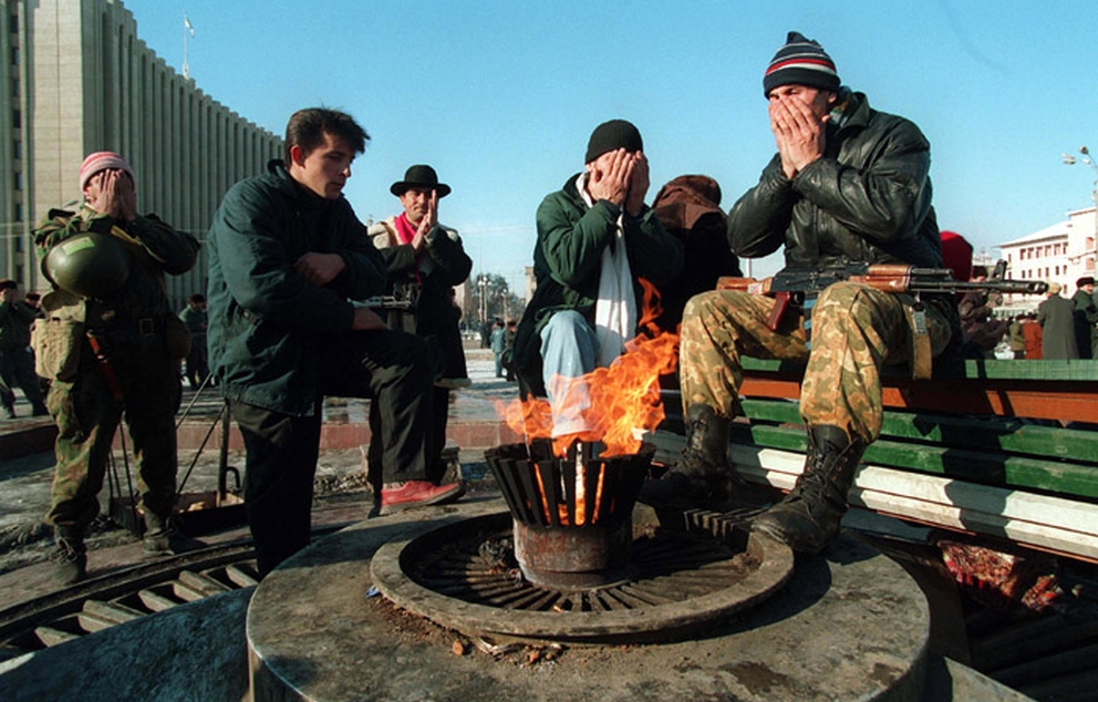 Chechen fighters pray in front of the Presidential Palace in Grozny December 1994 Mikhail Evstafiev