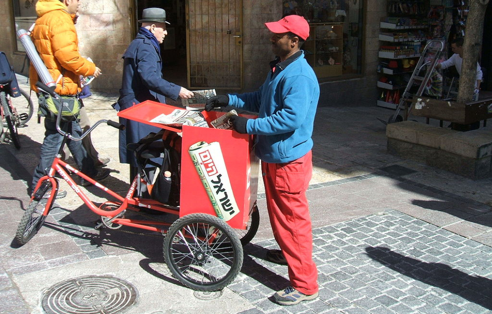 Distributing copies of the free daily Hebrew newspaper Israel HaYom in Jerusalem HovevShira