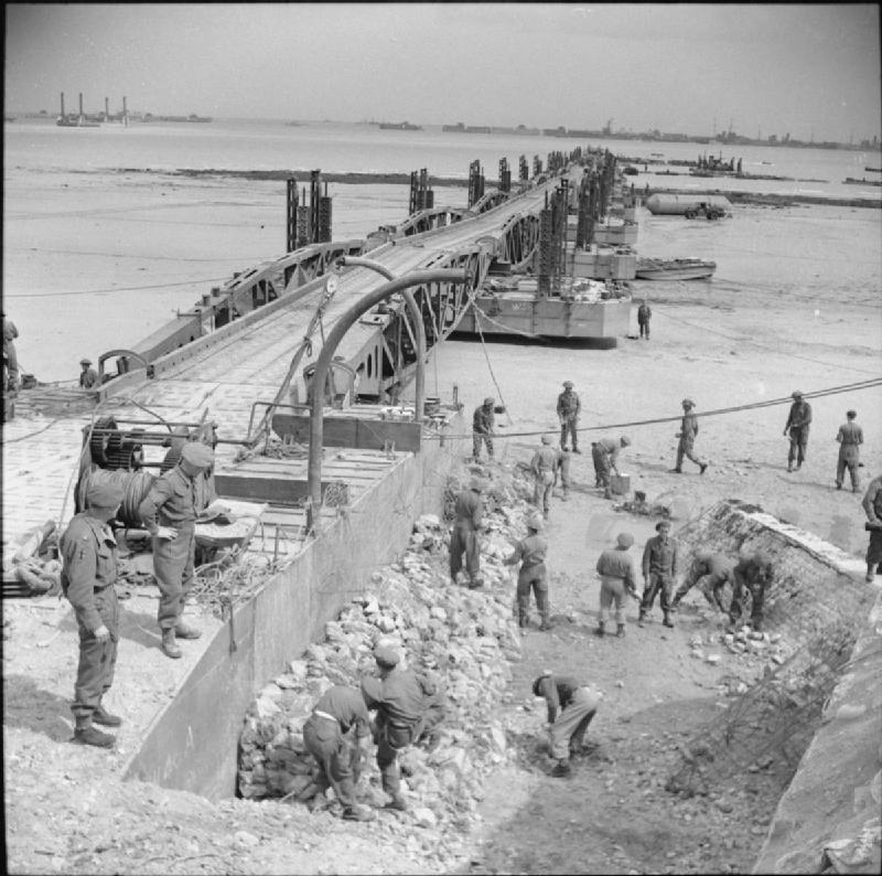 Engineers at work on the roadway leading to the Mulberry artificial harbour at Arromanches 14 June 1944 Harrison